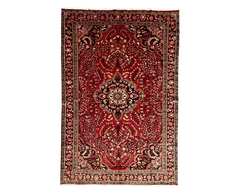 Persian crimson ground rug, central floral pattern medallion surrounded by trailing foliate decoration and tree of life motif