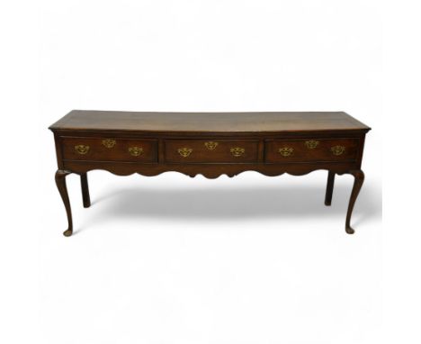 18th century oak dresser base, rectangular top over three cock-beaded drawers, shaped apron over cabriole supportsDimensions: