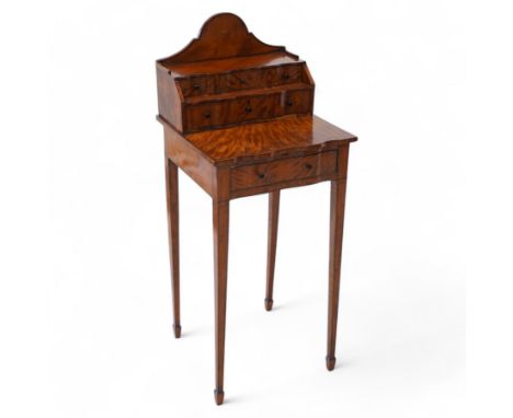 Early 19th century inlaid satinwood cheveret table or ladies writing desk, the shaped arched raised back over two tiers of co