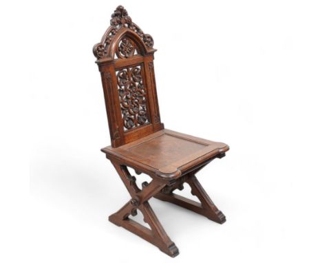 In the manner of Augustus Pugin - 19th century Gothic Revival oak hall chair, shaped pediment carved and pierced with foliate