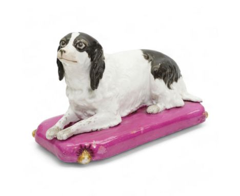 Mid 19th century Copeland & Garrett model of a recumbent spaniel upon a pink tasselled cushion, printed marks beneath, L20cm 