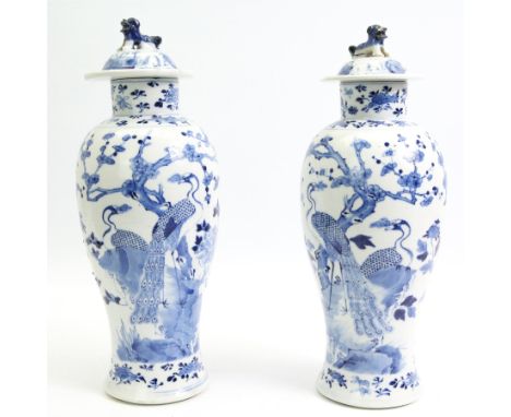 Pair of 19th/ early 20th century Chinese blue and white vases and covers, each of baluster form, painted in underglaze blue w