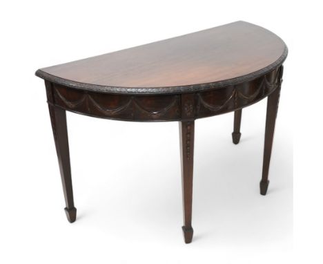 Early 20th century Hepplewhite Revival mahogany console table, demi-lune top with carved moulded edge, the frieze decorated w