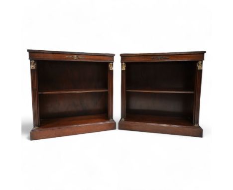 Pair of Neoclassical Empire design mahogany open bookcases, the rectangular top with reeded edge over a plain frieze decorate