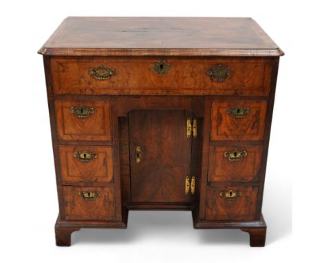 George II figured walnut knee-hole desk, the rectangular quarter-matched veneer top with moulded edge, crossbanding and feath