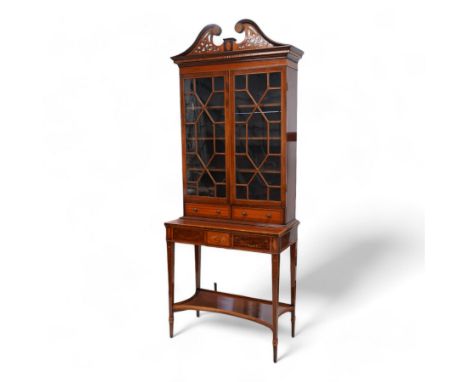 Early 19th century mahogany and satinwood bookcase on stand, scrolled swan neck pediment with pierced panels, satinwood friez