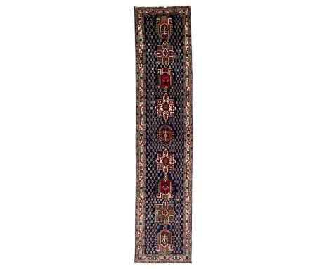 Persian indigo ground runner, the field decorated with nine medallions, surrounded by lattice pattern with repeating flower h