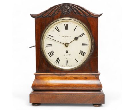 Brooks of London- Regency 8-day rosewood bracket clock c1825, with a serpentine shaped pediment and foliate carving on an oge