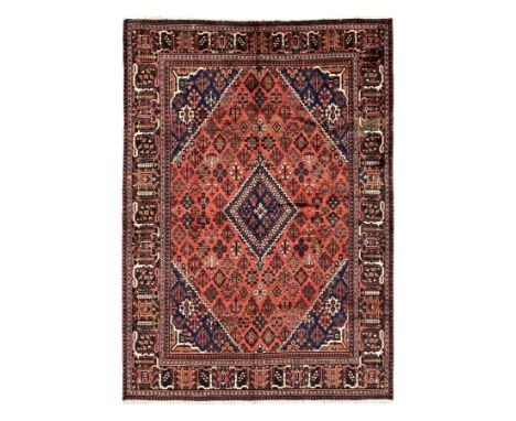 Persian Joshgan red ground rug, the medallion, field and spandrels decorated with clusters of Pitrak and tree of life motifs,