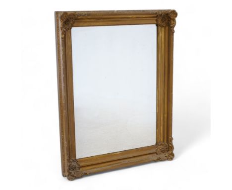 19th century gilt wood and gesso framed wall mirror, moulded rectangular swept frame, each corner decorated with floral carto