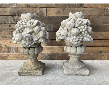 Pair of cast stone garden wall or gate finials depicting Fruit Piers, raised on separate circular squat column with plinth ba