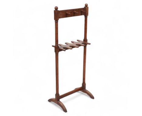 19th century mahogany whip and boot stand, ring turned pillars supporting six turned hooks and recessed boot holders, on arch