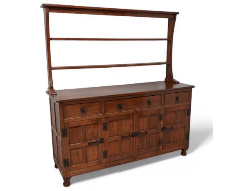 Acornman - oak dresser, raised two heights plate rack over three drawers and panelled cupboards, fitted with wrought metal fi