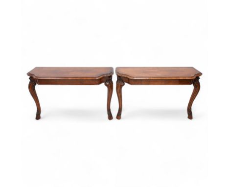 Pair of Georgian walnut console tables, the shaped rectangular cross-banded top with moulded edge over a banded frieze, raise