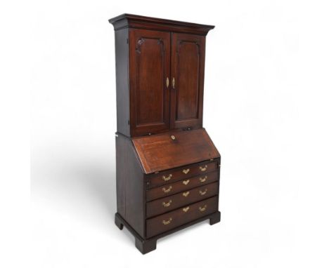 18th century mahogany bureau bookcase, cavetto moulded cornice over two panelled doors and candle slides, the interior fitted