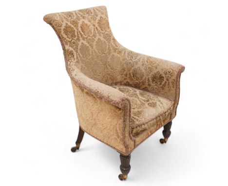 Early 19th century mahogany framed armchair, curved form with rolled cresting, upholstered in raised foliate pattern fabric, 