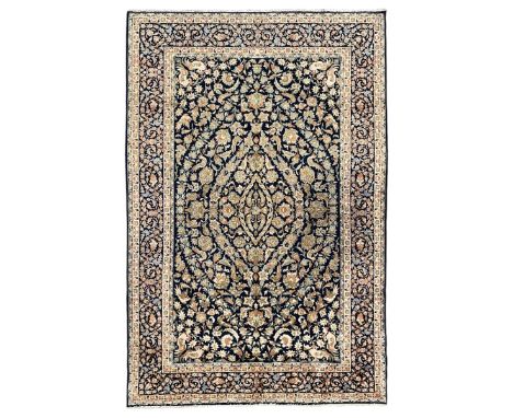 Persian Kashan indigo ground rug, the field consisting of trailing flower head bands and leafy branches, decorated with kuş o