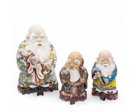 Group of three Chinese stoneware figures, modelled as the Three Stars or 'Sanxing' Gods of Fortune bearing a scroll, Prosperi