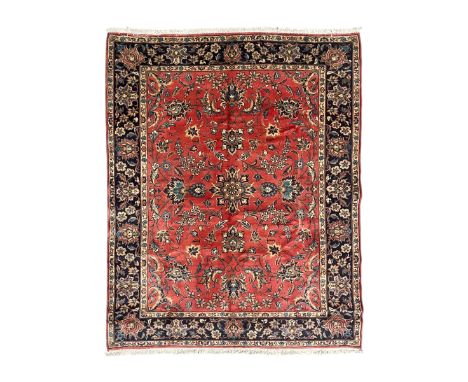 Persian Kashan red ground rug, the field decorated with trailing leafy branches and large palmettes, scrolling border decorat