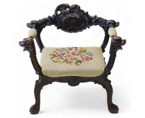 19th century Italian heavily carved stained walnut open armchair, the back rail carved with a large central cartouche decorat