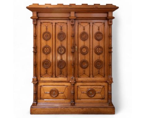 19th century pitch pine ecclesiastical vestment wardrobe or sacristy cabinet, crenelated and projecting moulded cornice over 