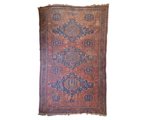 Old Persian red ground flat woven carpet, the field with three large medallions surrounded by small stylised flower head moti