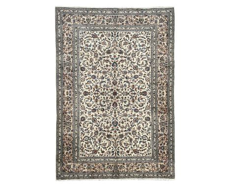 Persian Kashan ivory ground rug, decorated with curled leafy branches and palmettes, the border with scrolling design decorat