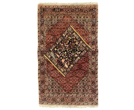 Persian Bidjar peach ground rug, the field decorated with repeating Herati motifs surrounding an off-centre lozenge medallion