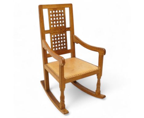 Mouseman - oak rocking armchair, double pierced and carved high lattice back, upholstered in tan leather with stud work, rais