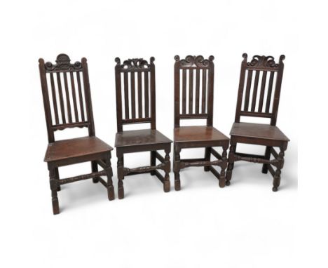 Mixed set of four 18th century oak side chairs, each with scroll carved pediment over vertical slat back, plank seat over tur