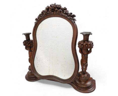 Late 19th century Northern European carved walnut dressing table mirror, the moulded arch top frame carved with flower heads 