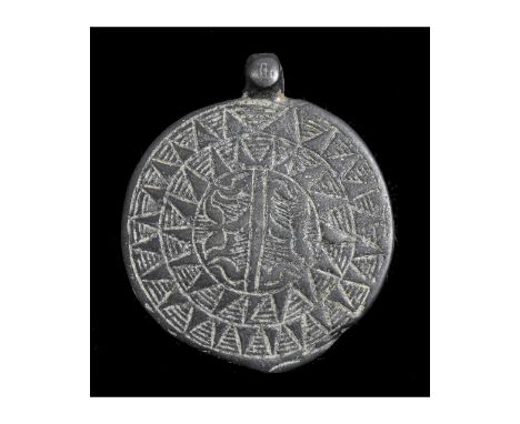 Ca. 100 BC - 1000 AD. Wearable Celtic Iron Age, Druidic flat section pendant; It depicts a large sun motif; a stylized vagina