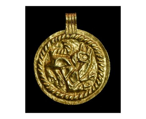 Ca.900-1100 AD. Important, Early Viking broad repoussé Bracteate gold-foil pendant with ribbed loop and a depiction of a Gryp