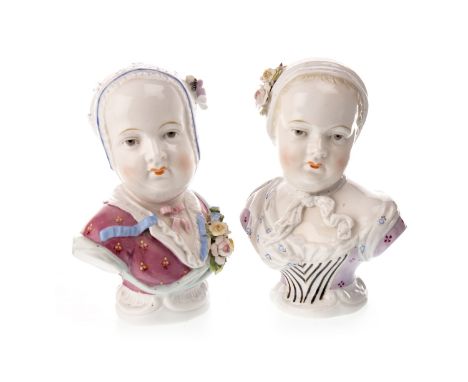 PAIR OF SITZENDORF BUSTS OF YOUNG WOMEN, each with floral decorated bonnet, on a fixed base, 6.5 cm high