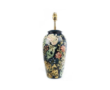 MOORCROFT 'GOLDEN LILY' PATTERN LAMP BASE, of ovoid shape, tube-lined with lilies, tuilips, bluebells and foliage on a blue g