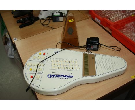A SUZUKI ELECTRONIC OMNI CHORD, with PSU and a clockwork metronome (no winder)