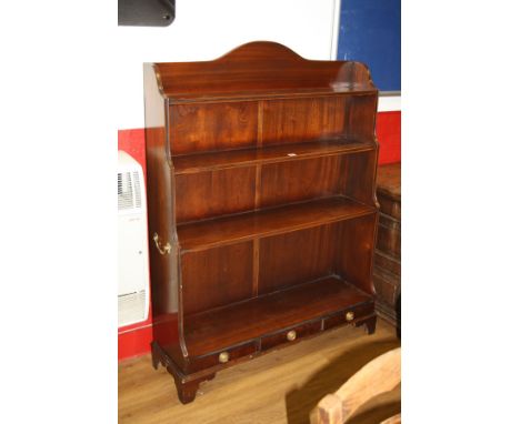 A MODERN REPRODUCTION CASCADE BOOKCASE, with three fixed shelves over three drawers with brass ring handles and drop hinges t