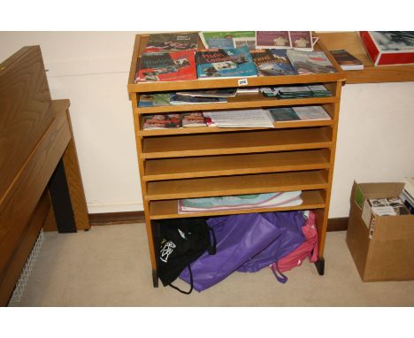 AN OAK VENEERED LEAFLET STAND WITH FIVE PULL OUT SHELVES, one static and an angle reading top 78x49x98cm high (s.d)