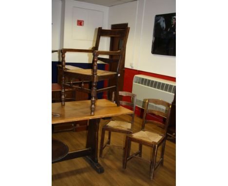 AN EARLY 20TH CENTURY OAK ELBOW CHAIR, with rush seating and carved back rails and two rush seated ladder back chairs (3) (s.