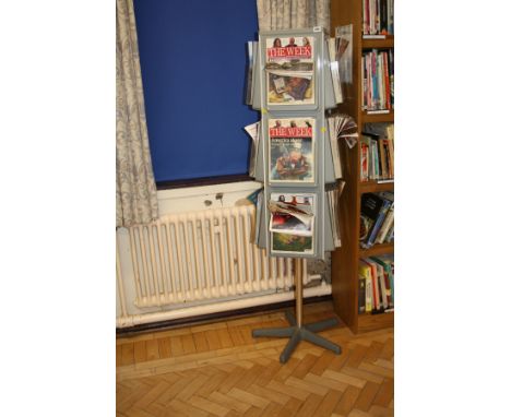 A ROTATING MAGAZINE/LEAFLET STAND, with twelve clear plastic holders over a moulded grey plastic core 169cm high