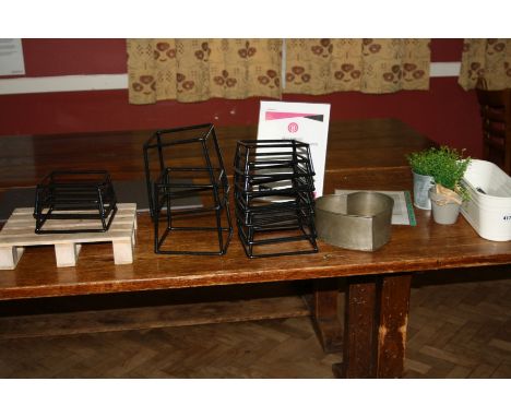 EIGHT MODERN RUBBERISED METAL TRIVETS, 18cm square 8cm high, two similar but 18cm high, an ornamental mini pallet table decor