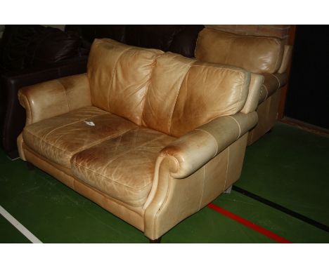 AN ANTIQUED FAWN LEATHER TWO PIECE SUITE, consisting of a two seater sofa (147cm wide) and an arm chair (90cm wide) (s.d)