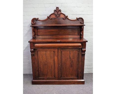 A Victorian rosewood ledge back chiffonier with cushion drawer over cupboards, 107cm wide x 154cm high.