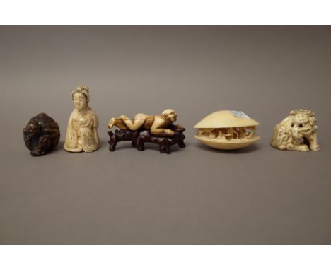  A group of Japanese carvings, late 19th/early 20th century,  comprising; an ivory  netsuke of a seated  baku, 4.25cm. high; 