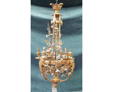 A modern gilt bronze six branch chandelier of classical Renaissance style, cast with cherub figures, bows and swags and profu