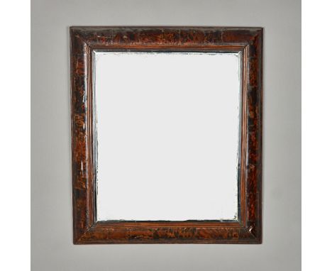 An 18th century rectangular mirror with cushion tortoiseshell frame and ebonised slip, 81cm wide x 94cm high. Illustrated 