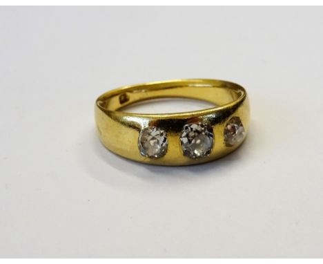 A gold and diamond set three stone ring, gypsy set with a row of cushion shaped diamonds, detailed 18, ring size J 1/2, gross