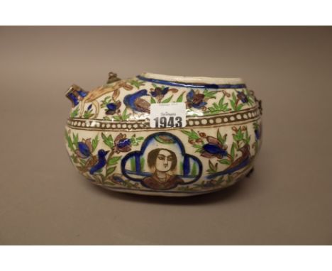 A Qajar pottery begging bowl (kashkul), late 19th century, painted with four head and shoulder portrait panels against a grou