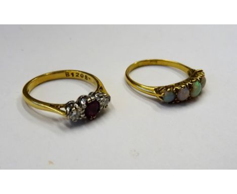 An 18ct gold ring, mounted with a row of five graduated opals, ring size N and a half and an 18ct gold, ruby and diamond thre