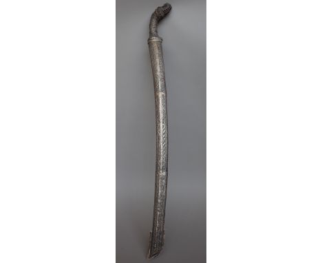 A South East Asian sword, 19th century with curved steel blade, 67cm and a foliate embossed white metal and carved wood handl